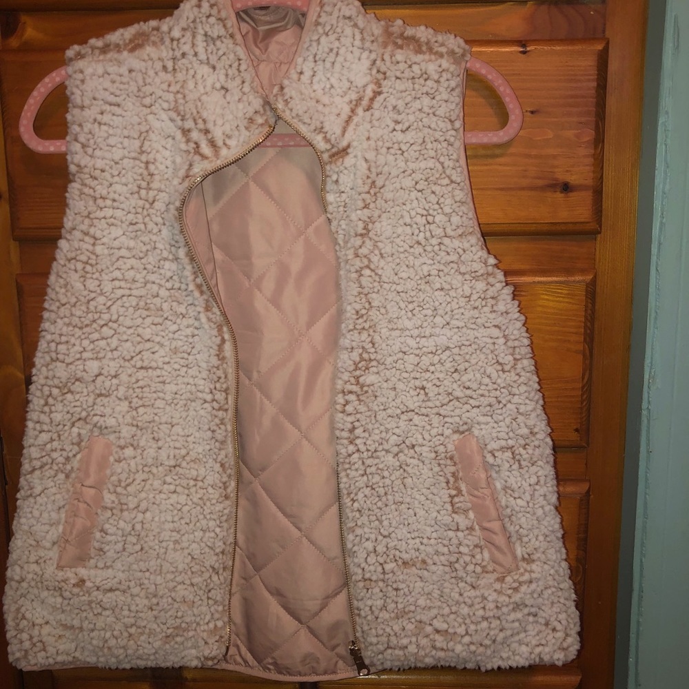 Reversible pink vest with pockets on both sides.